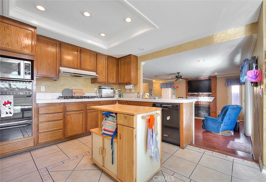 32 Rising Hill Road Phillips Ranch, CA 91766 - Photo 11 of 63 a kitchen with a sink a counter top space and appliances