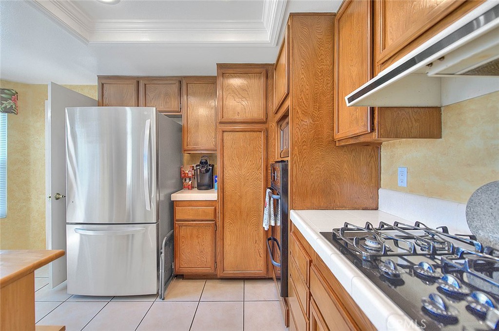 32 Rising Hill Road Phillips Ranch, CA 91766 - Photo 12 of 63 a kitchen with stainless steel appliances granite countertop a refrigerator and a stove