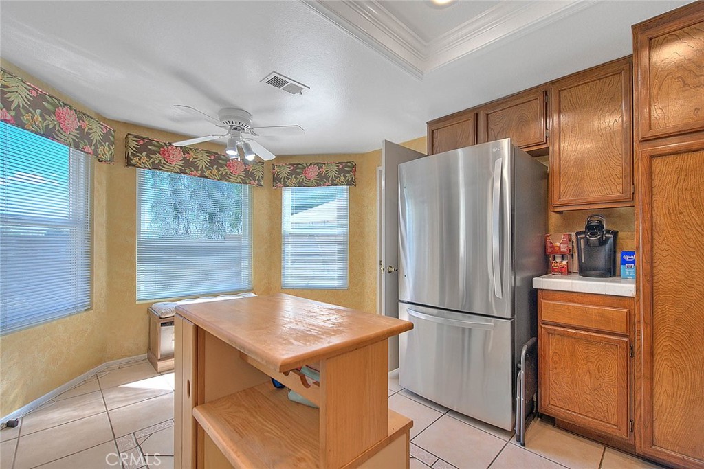 32 Rising Hill Road Phillips Ranch, CA 91766 - Photo 13 of 63 a kitchen with refrigerator cabinets and wooden floor