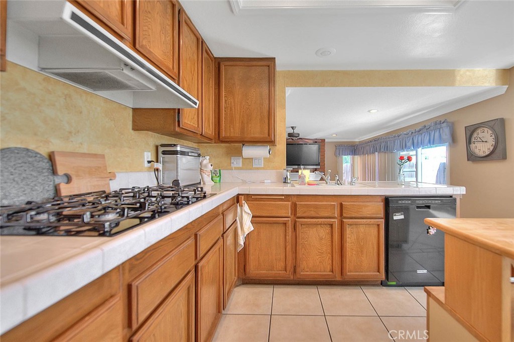 32 Rising Hill Road Phillips Ranch, CA 91766 - Photo 14 of 63 a kitchen with stainless steel appliances granite countertop a sink stove and cabinets