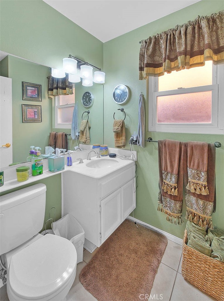 32 Rising Hill Road Phillips Ranch, CA 91766 - Photo 24 of 63 a bathroom with a toilet sink and mirror