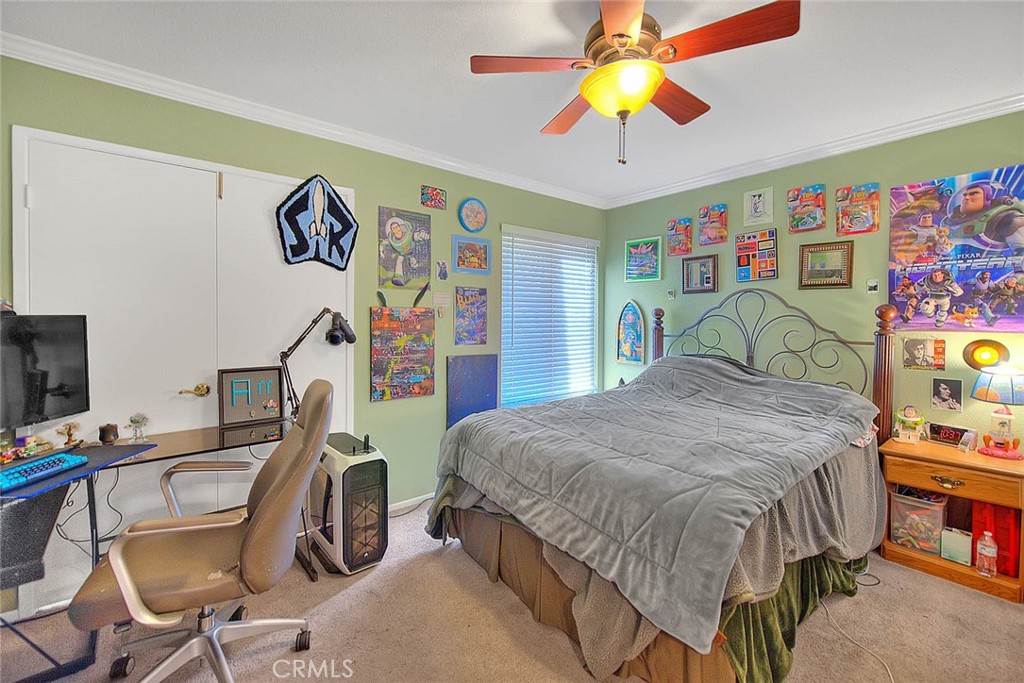 32 Rising Hill Road Phillips Ranch, CA 91766 - Photo 25 of 63 a bedroom with a bed and a chandelier