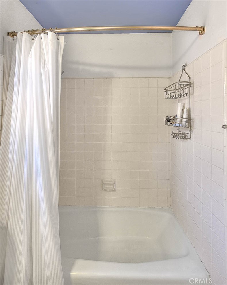 32 Rising Hill Road Phillips Ranch, CA 91766 - Photo 29 of 63 a bathroom with a shower curtain and a window