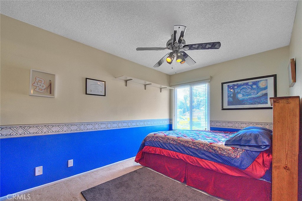 32 Rising Hill Road Phillips Ranch, CA 91766 - Photo 30 of 63 a bedroom with a bed and a chandelier