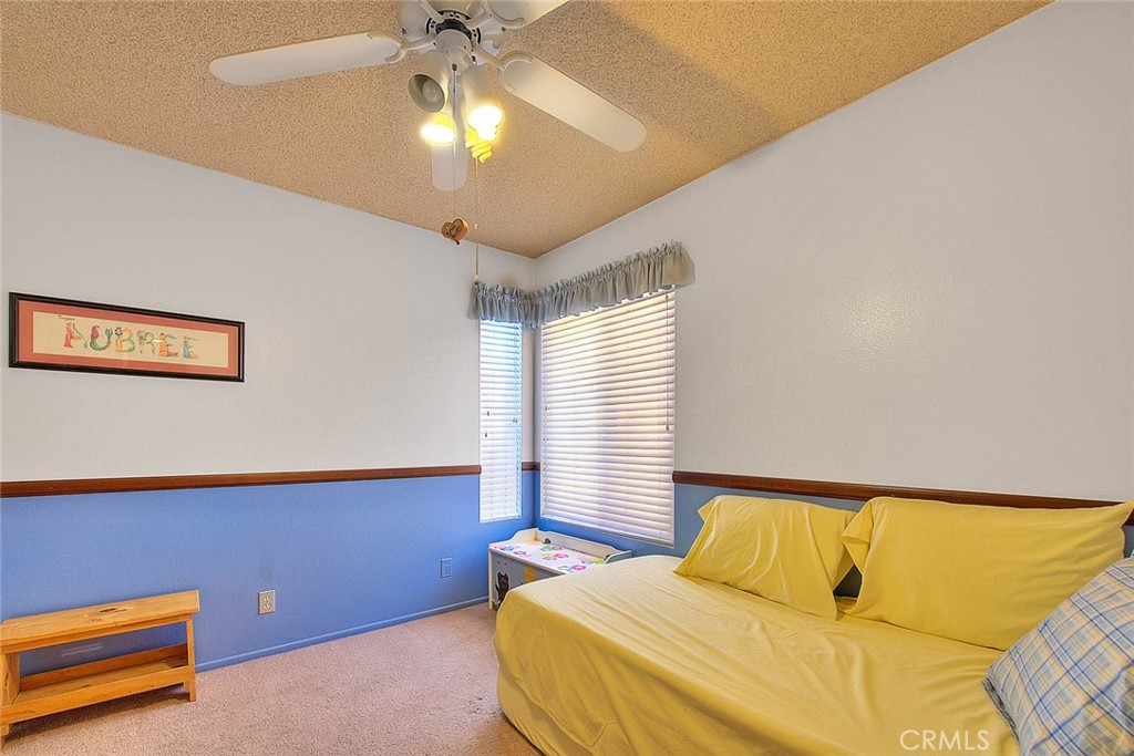 32 Rising Hill Road Phillips Ranch, CA 91766 - Photo 31 of 63 a bedroom with a bed and a chandelier