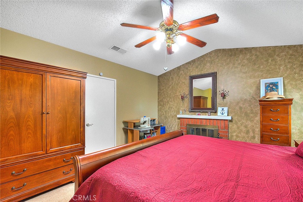 32 Rising Hill Road Phillips Ranch, CA 91766 - Photo 32 of 63 a bedroom with a bed and a chandelier