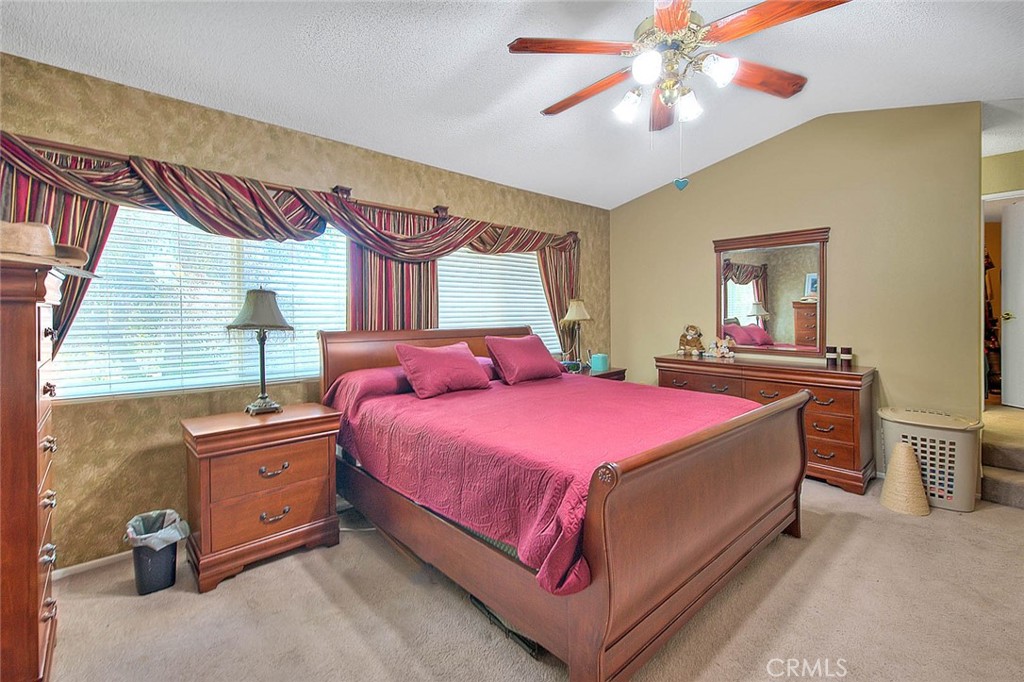 32 Rising Hill Road Phillips Ranch, CA 91766 - Photo 33 of 63 a bedroom with a bed and a chandelier