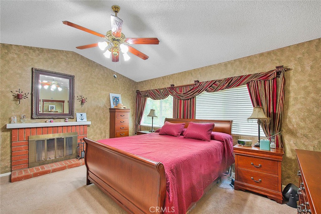 32 Rising Hill Road Phillips Ranch, CA 91766 - Photo 34 of 63 a bedroom with a bed and a chandelier