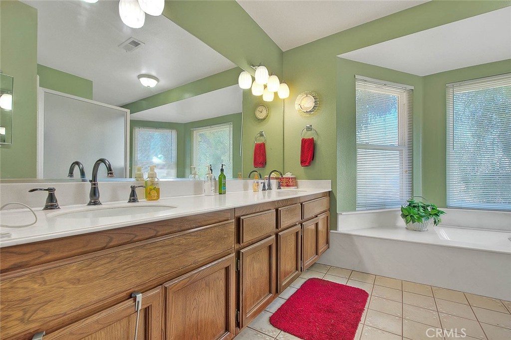 32 Rising Hill Road Phillips Ranch, CA 91766 - Photo 38 of 63 a spacious bathroom with a double vanity sink shower and a mirror