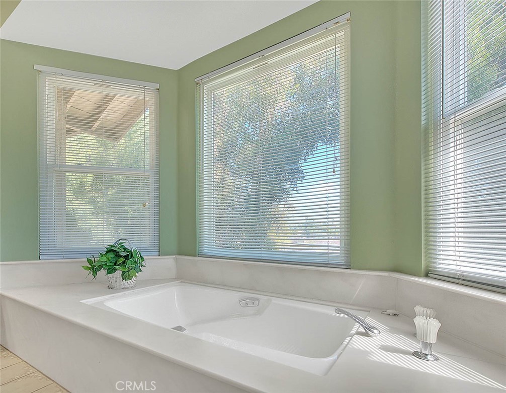32 Rising Hill Road Phillips Ranch, CA 91766 - Photo 42 of 63 a white bath tub sitting in a bathroom next to a window