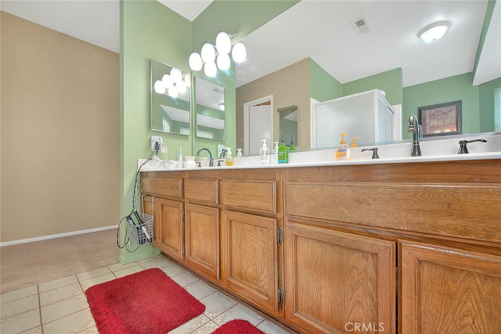 32 Rising Hill Road Phillips Ranch, CA 91766 - Photo 43 of 63 a spacious bathroom with a sink mirror and vanity