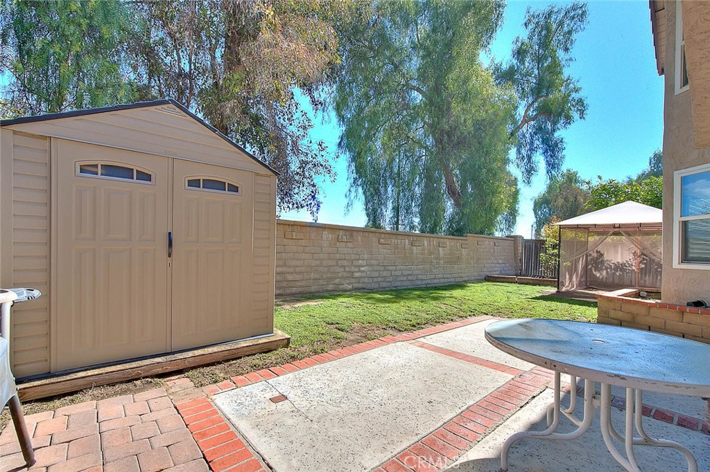 32 Rising Hill Road Phillips Ranch, CA 91766 - Photo 47 of 63 a view of a backyard with table and chairs and wooden fence