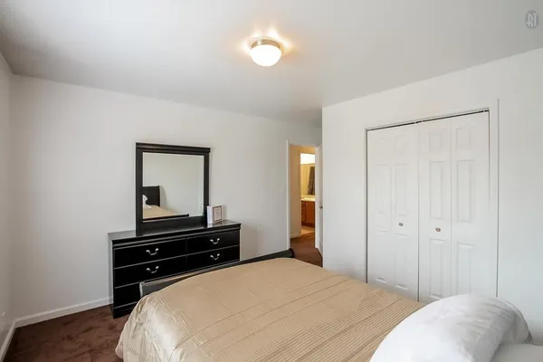a bedroom with a bed and a piano