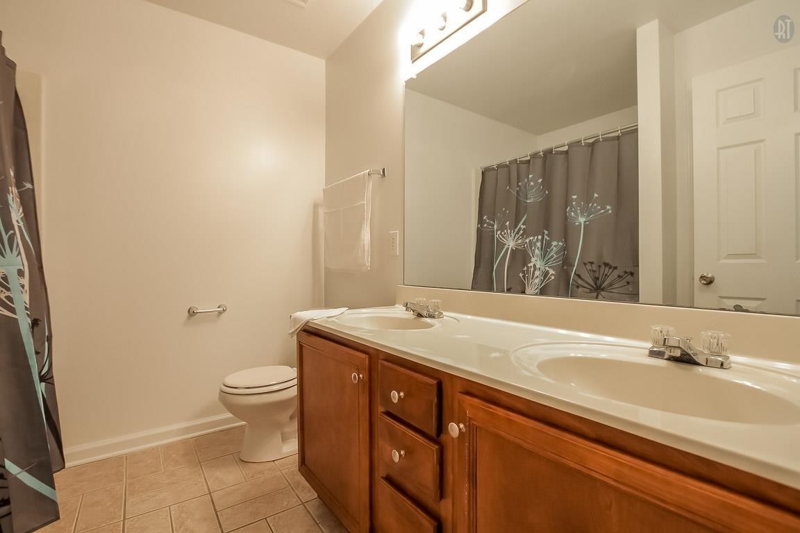 535 Lafayette Road, Unit H4 Clarksville, TN 37042 - Photo 18 of 24 a bathroom with a granite countertop sink toilet and shower