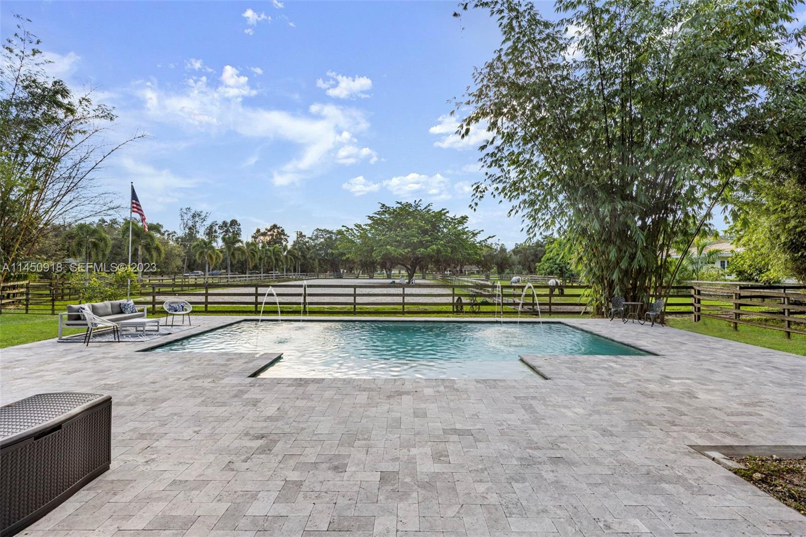 a view of a swimming pool with an outdoor space and seating area