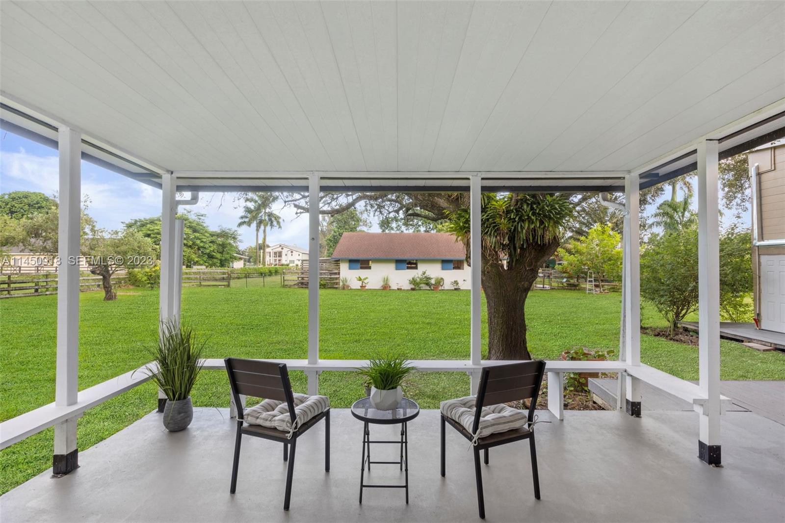 6410 Melaleuca Road Southwest Ranches, FL 33330 - Photo 19 of 50 a view of a chairs and table in patio with a garden