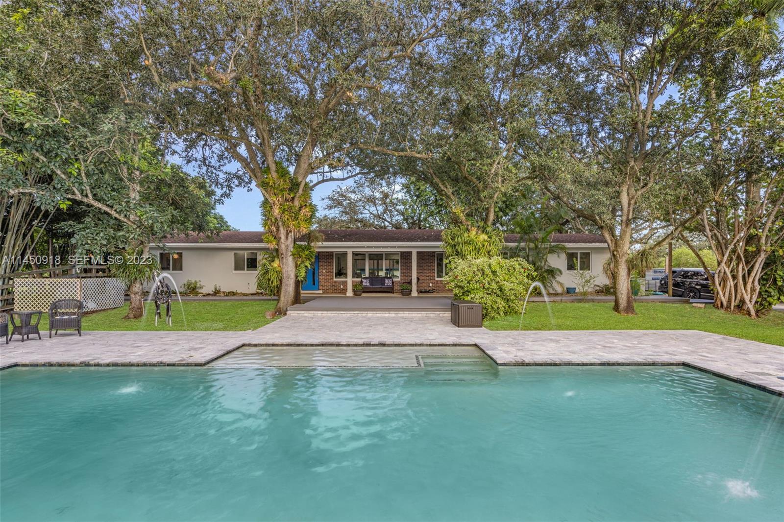 6410 Melaleuca Road Southwest Ranches, FL 33330 - Photo 23 of 50 a front view of a house with a yard and trees
