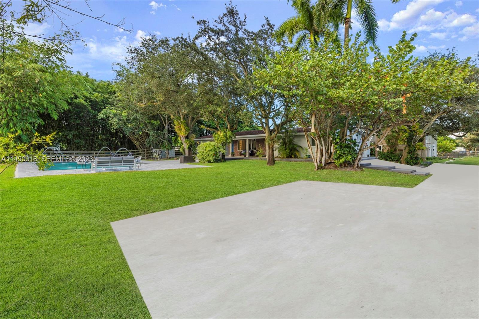 6410 Melaleuca Road Southwest Ranches, FL 33330 - Photo 27 of 50 a view of a house with a big yard and large trees