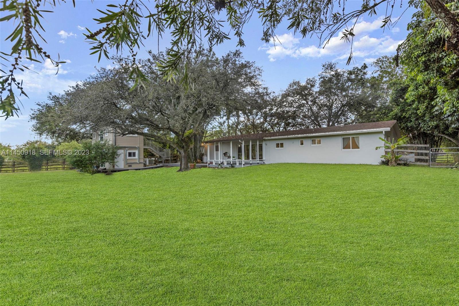 6410 Melaleuca Road Southwest Ranches, FL 33330 - Photo 29 of 50 a view of a house with a back yard