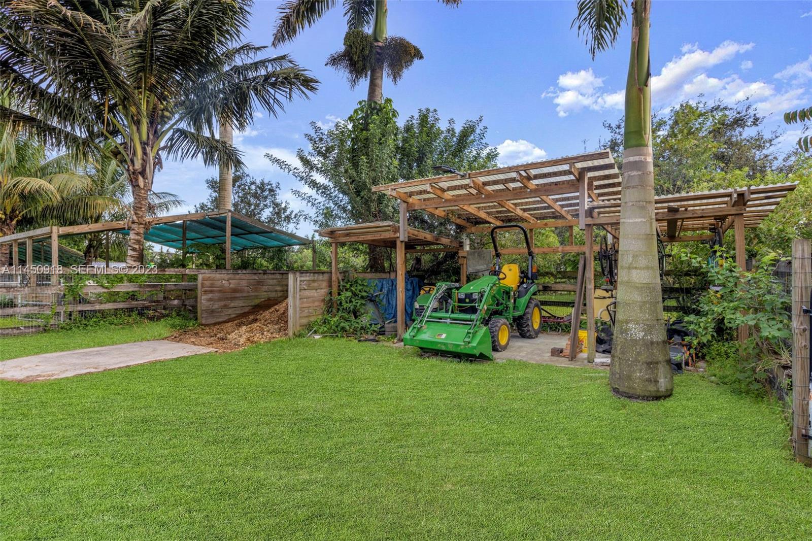 6410 Melaleuca Road Southwest Ranches, FL 33330 - Photo 39 of 50 a view of a chair and table in backyard of the house