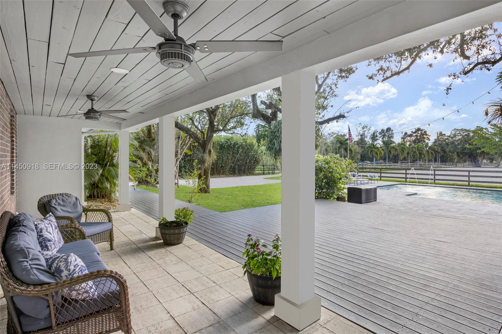 6410 Melaleuca Road Southwest Ranches, FL 33330 - Photo 4 of 50 a living room with furniture and a floor to ceiling window