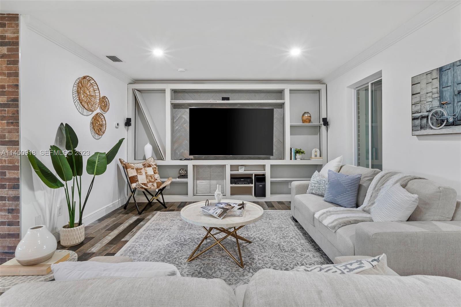 6410 Melaleuca Road Southwest Ranches, FL 33330 - Photo 8 of 50 a living room with furniture a flat screen tv and a floor to ceiling window