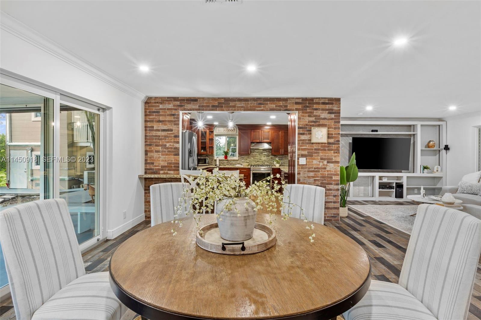 6410 Melaleuca Road Southwest Ranches, FL 33330 - Photo 10 of 50 a living room with furniture a flat screen tv and a large window