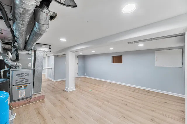 an empty room with wooden floor and staircase