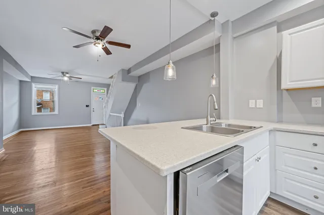 a kitchen with kitchen island a sink appliances and cabinets