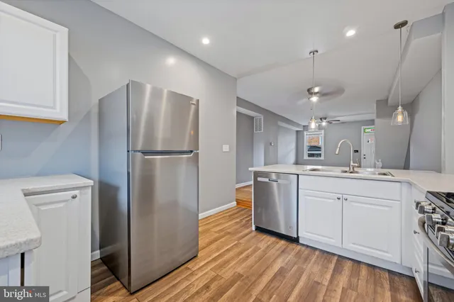 a kitchen with stainless steel appliances white cabinets and stove