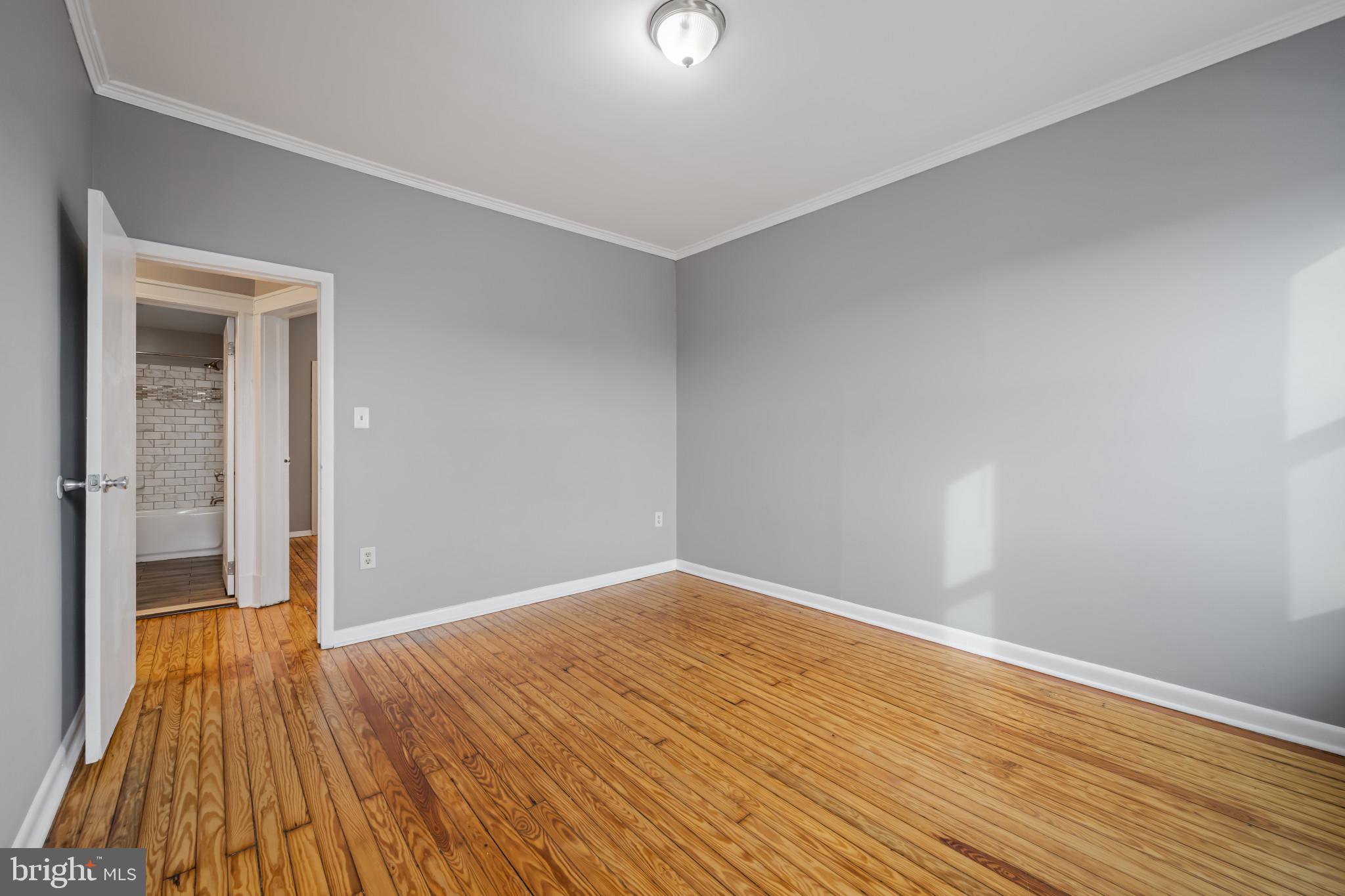 628 Savage Street Baltimore, MD 21224 - Photo 16 of 45 a view of empty room with wooden floor