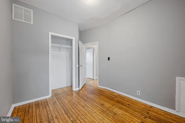 a bathroom with a sink a light fixture and a mirror