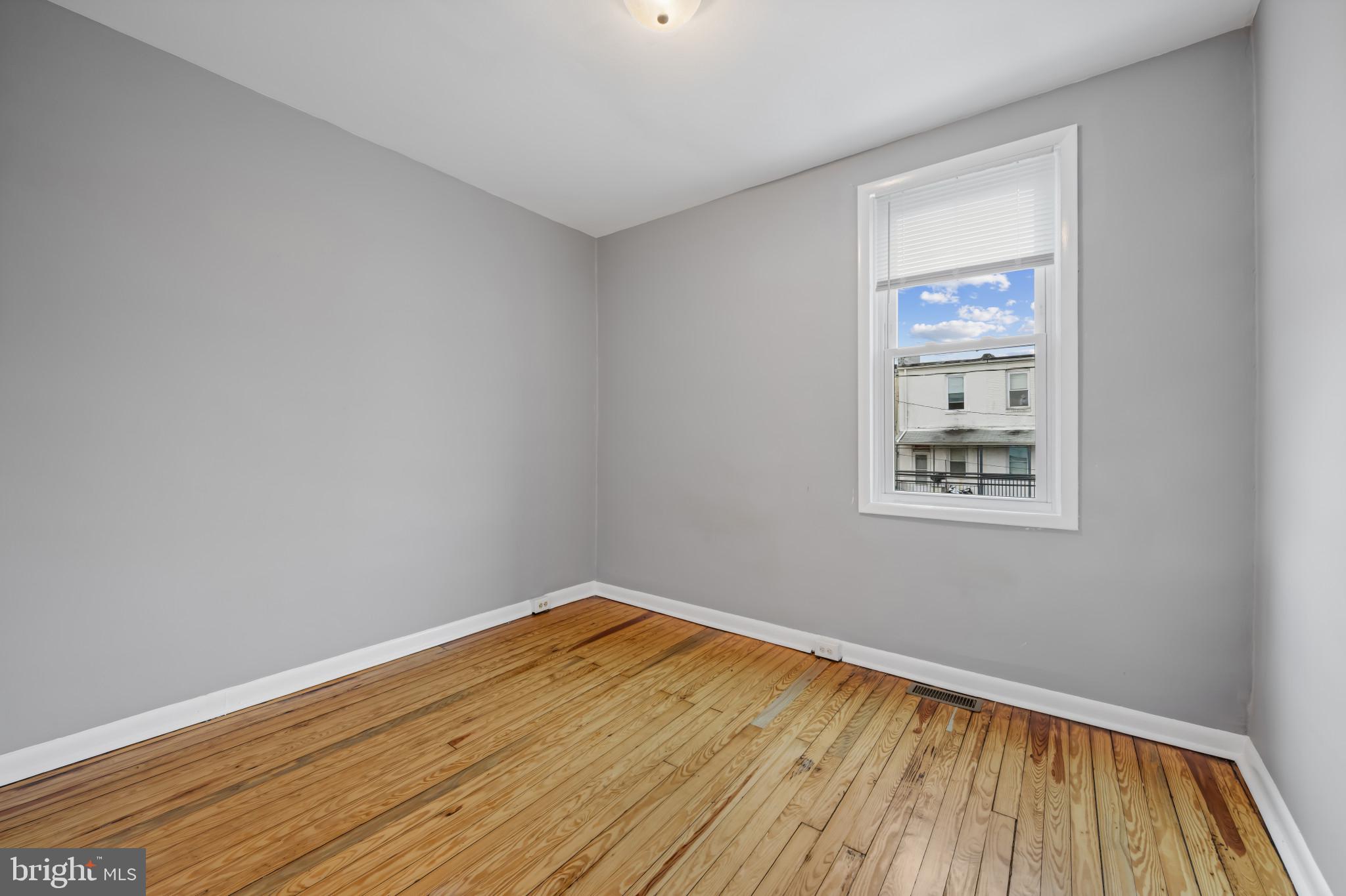 628 Savage Street Baltimore, MD 21224 - Photo 21 of 45 a view of a room with wooden floor and white walls