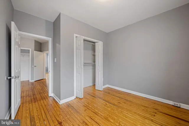 a view of a room with wooden floor and closet