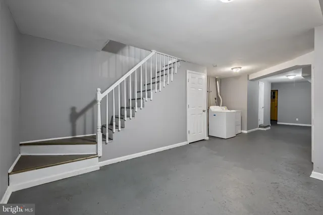 a view of a room with wooden floor and white walls