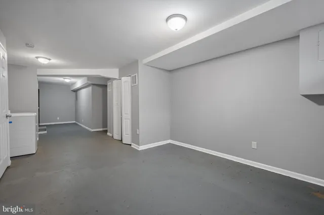 a view of a bedroom with wooden floor and a bathroom