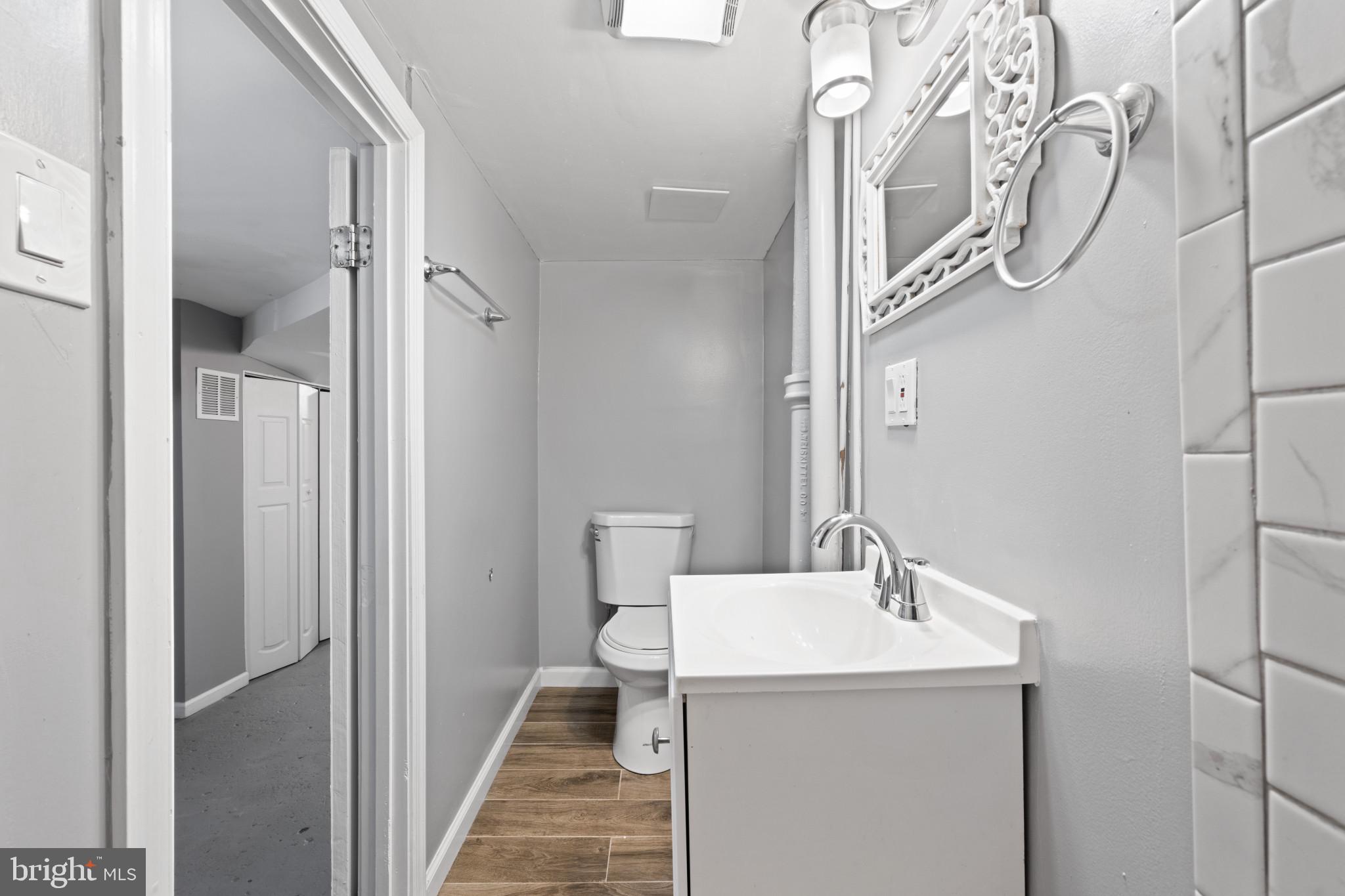 628 Savage Street Baltimore, MD 21224 - Photo 25 of 45 a bathroom with a sink a toilet and shower