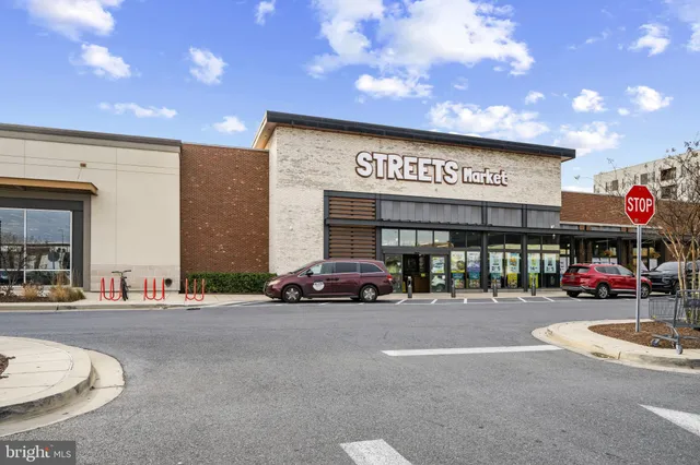 a building with car parked on the side of road
