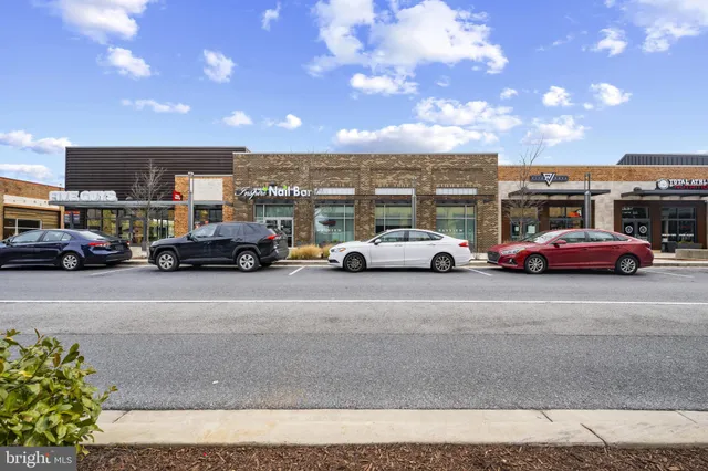 a view of a building with cars parked