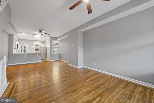 a view of a livingroom with wooden floor and white walls