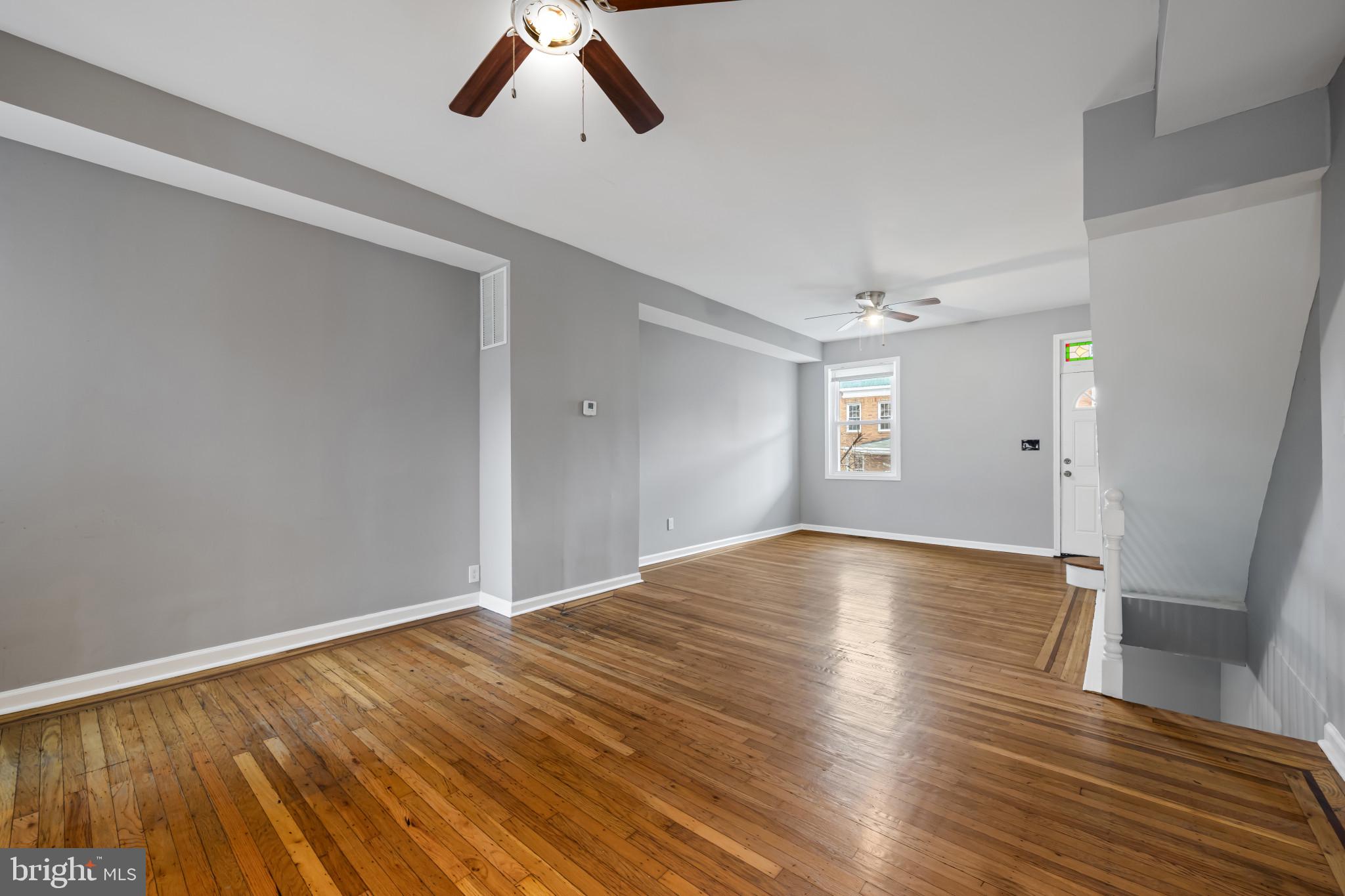 628 Savage Street Baltimore, MD 21224 - Photo 7 of 45 a view of empty room with wooden floor and fan