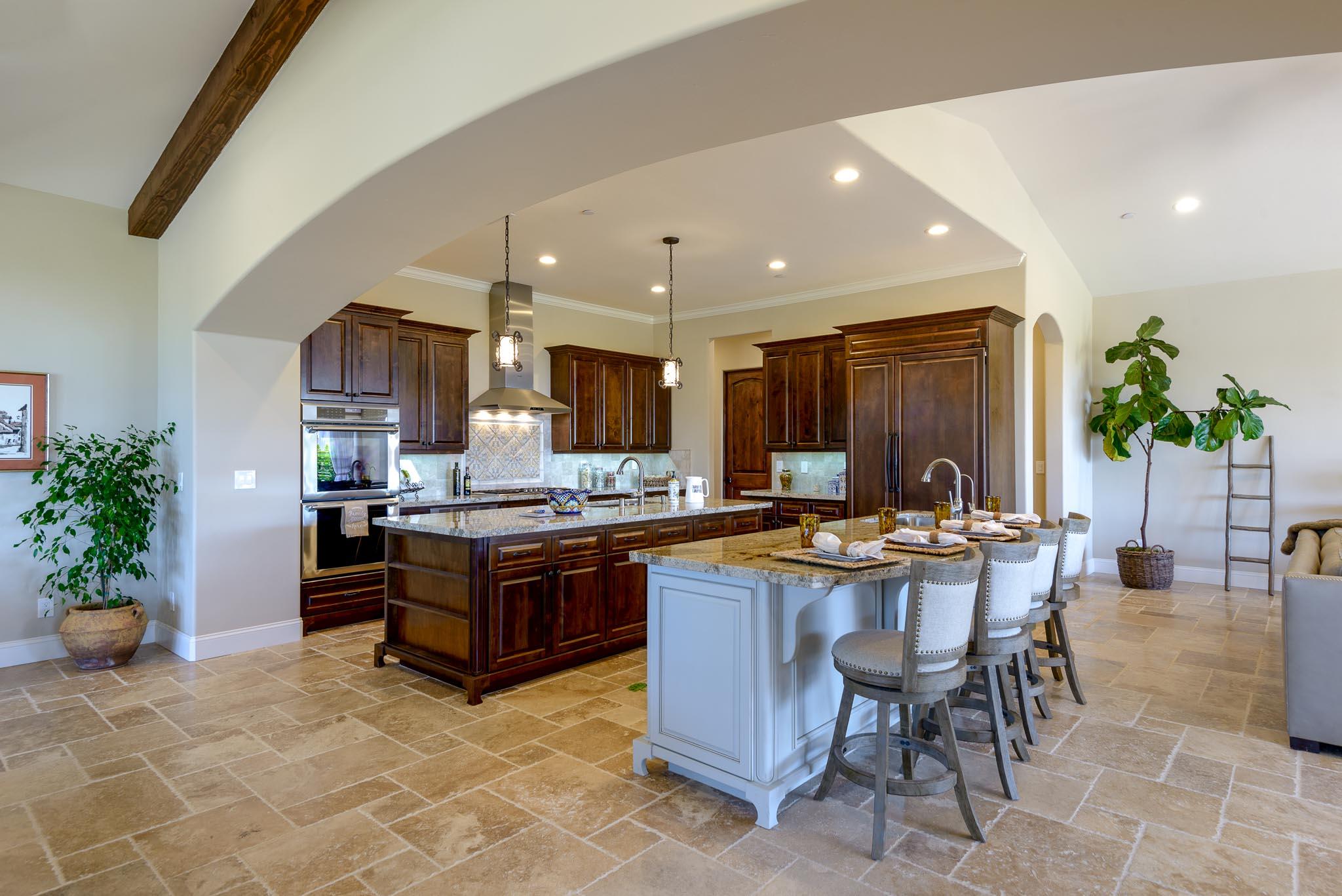 1210 Via Brigitte Santa Barbara, CA 93111 - Photo 2 of 15 a kitchen with stainless steel appliances granite countertop a stove top oven a dining table and chairs with wooden floor