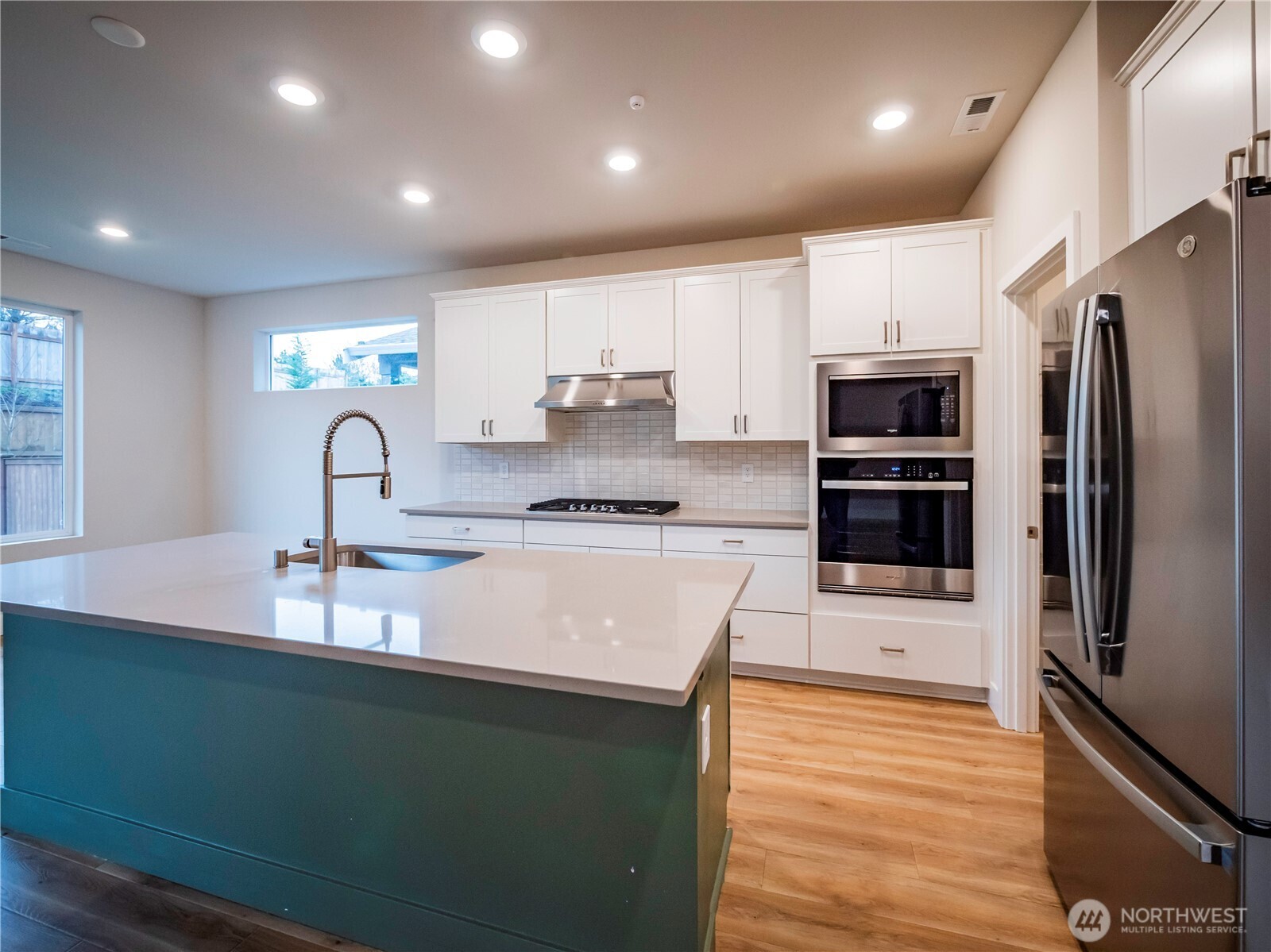 5393 Century Place Northeast Lacey, WA 98516 - Photo 5 of 33 a kitchen with kitchen island granite countertop a sink stove and refrigerator