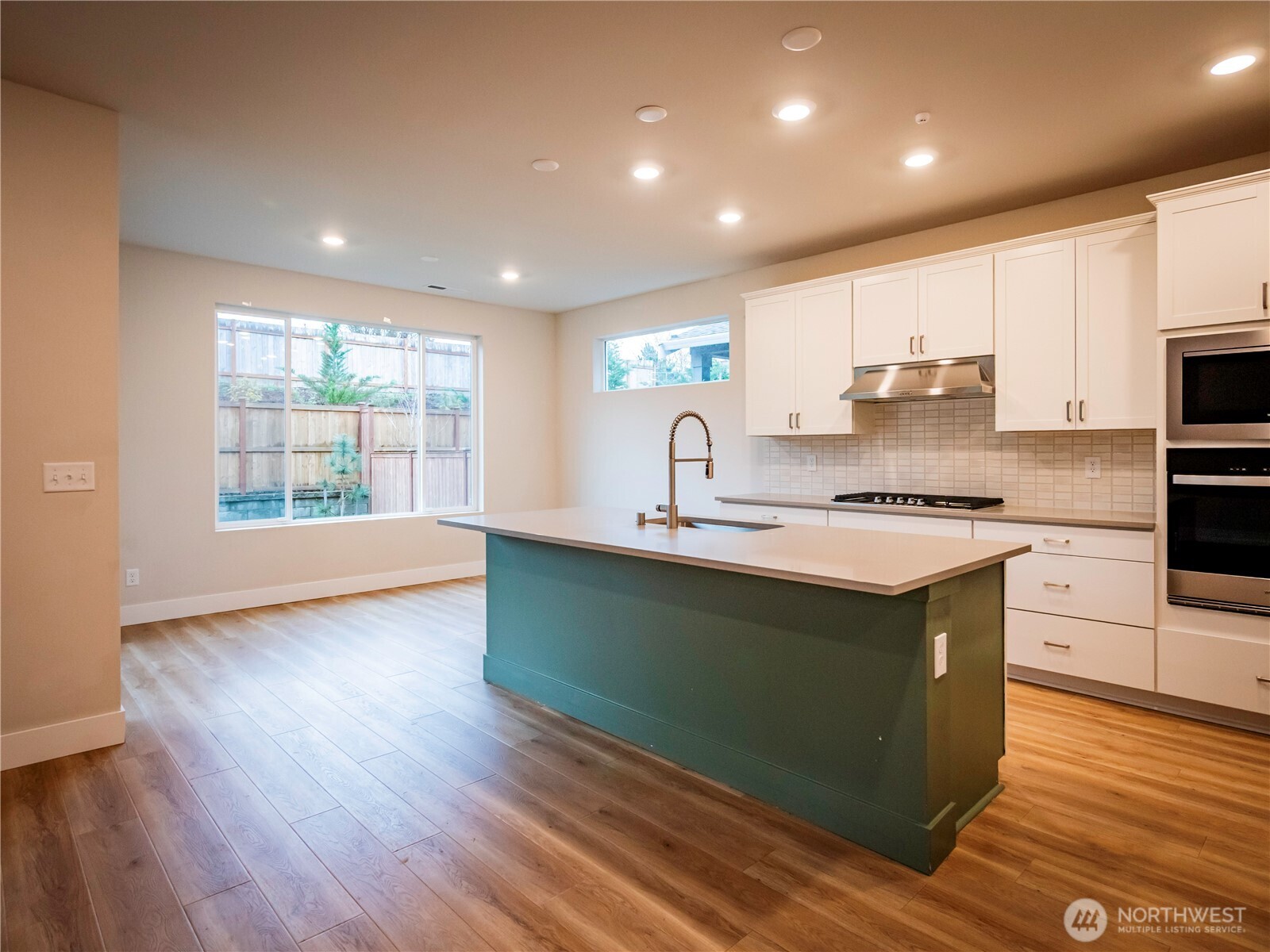 5393 Century Place Northeast Lacey, WA 98516 - Photo 7 of 33 a kitchen with kitchen island granite countertop a sink window and stainless steel appliances