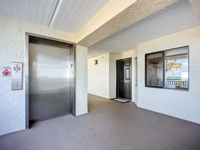 a large white kitchen with kitchen island a sink stainless steel appliances and cabinets