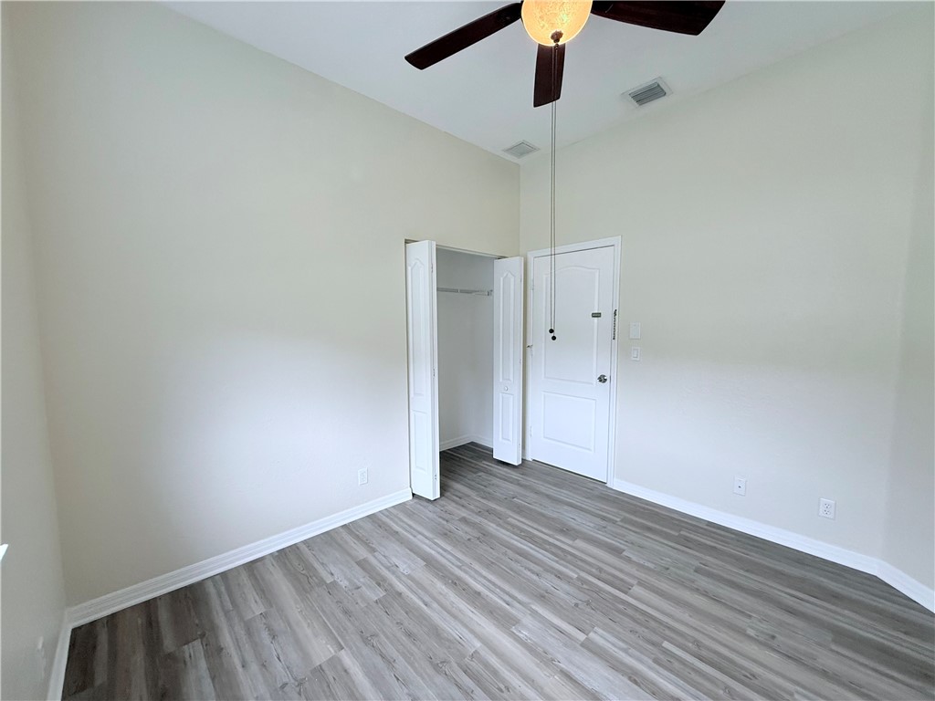 5837 Spanish River Road Fort Pierce, FL 34951 - Photo 16 of 34 a view of an empty room with wooden floor