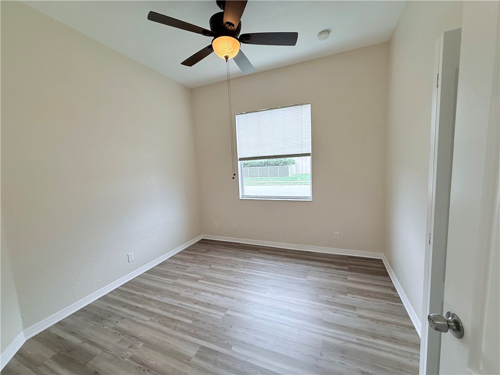 5837 Spanish River Road Fort Pierce, FL 34951 - Photo 18 of 34 wooden floor in an empty room with a window