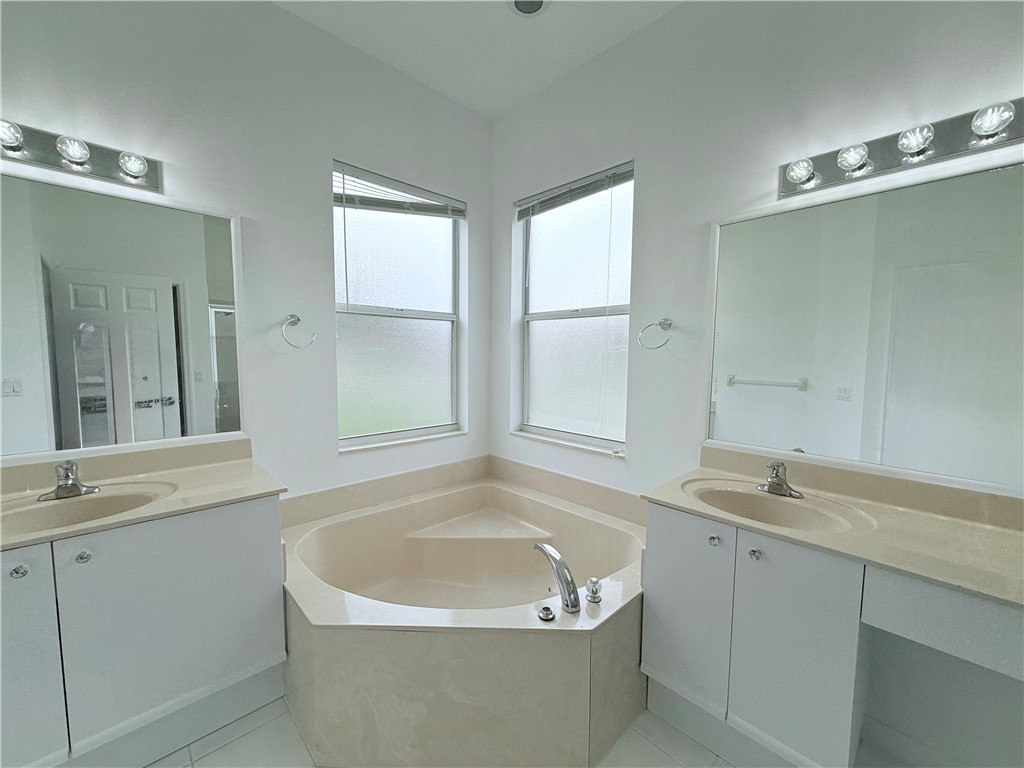 5837 Spanish River Road Fort Pierce, FL 34951 - Photo 21 of 34 a bathroom with a sink and a bathtub