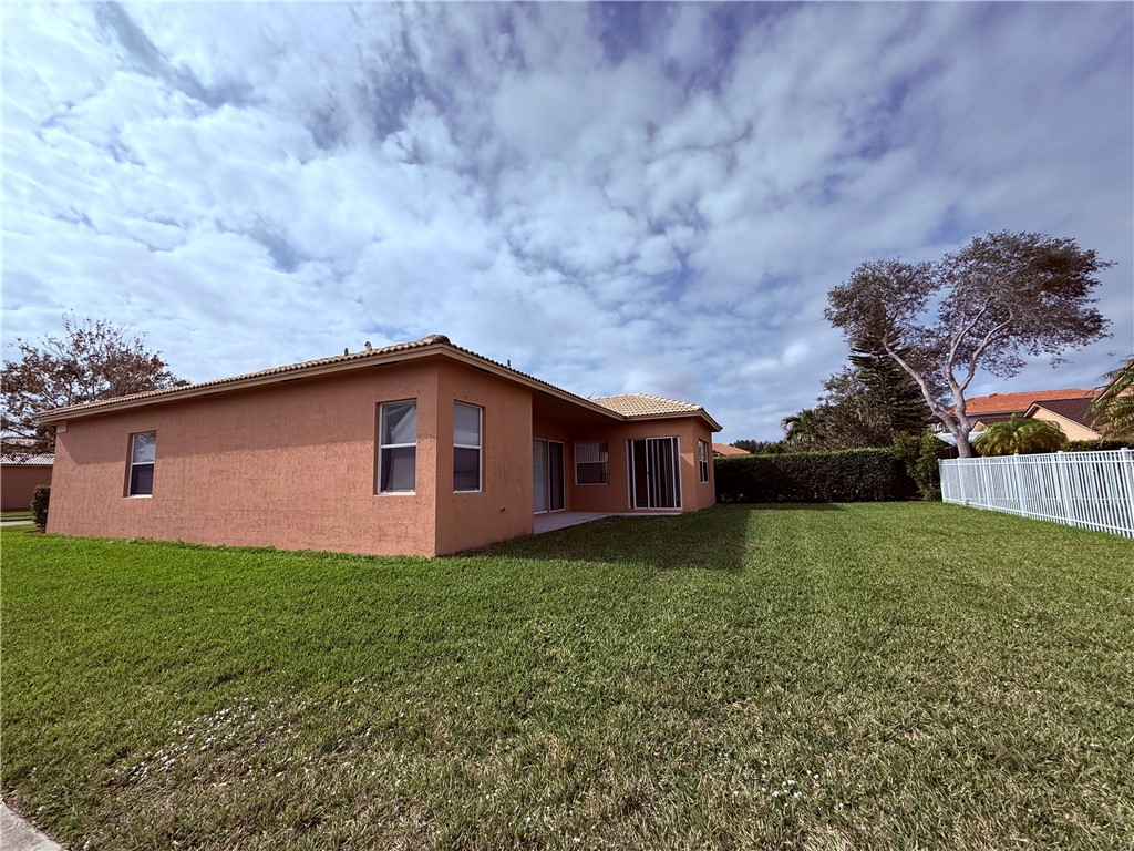 5837 Spanish River Road Fort Pierce, FL 34951 - Photo 27 of 34 a backyard of a house with lots of green space