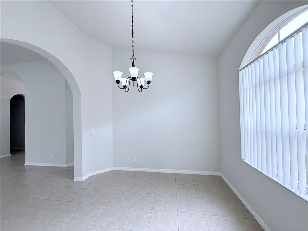 5837 Spanish River Road Fort Pierce, FL 34951 - Photo 9 of 34 wooden floor in an empty room with a window